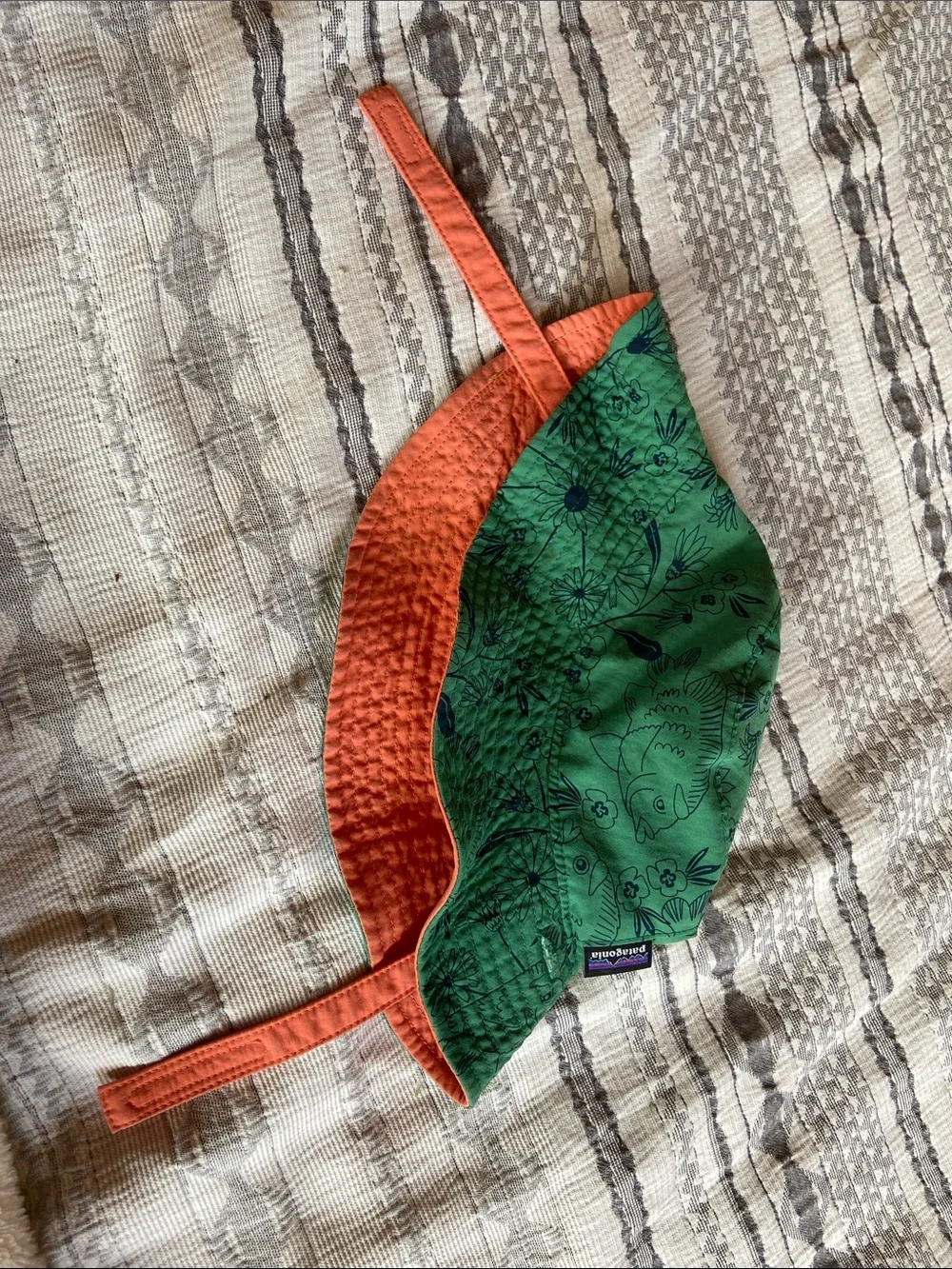 Patagonia Green Kids Sun Bucket Hat with Navy Fish and Floral Print.